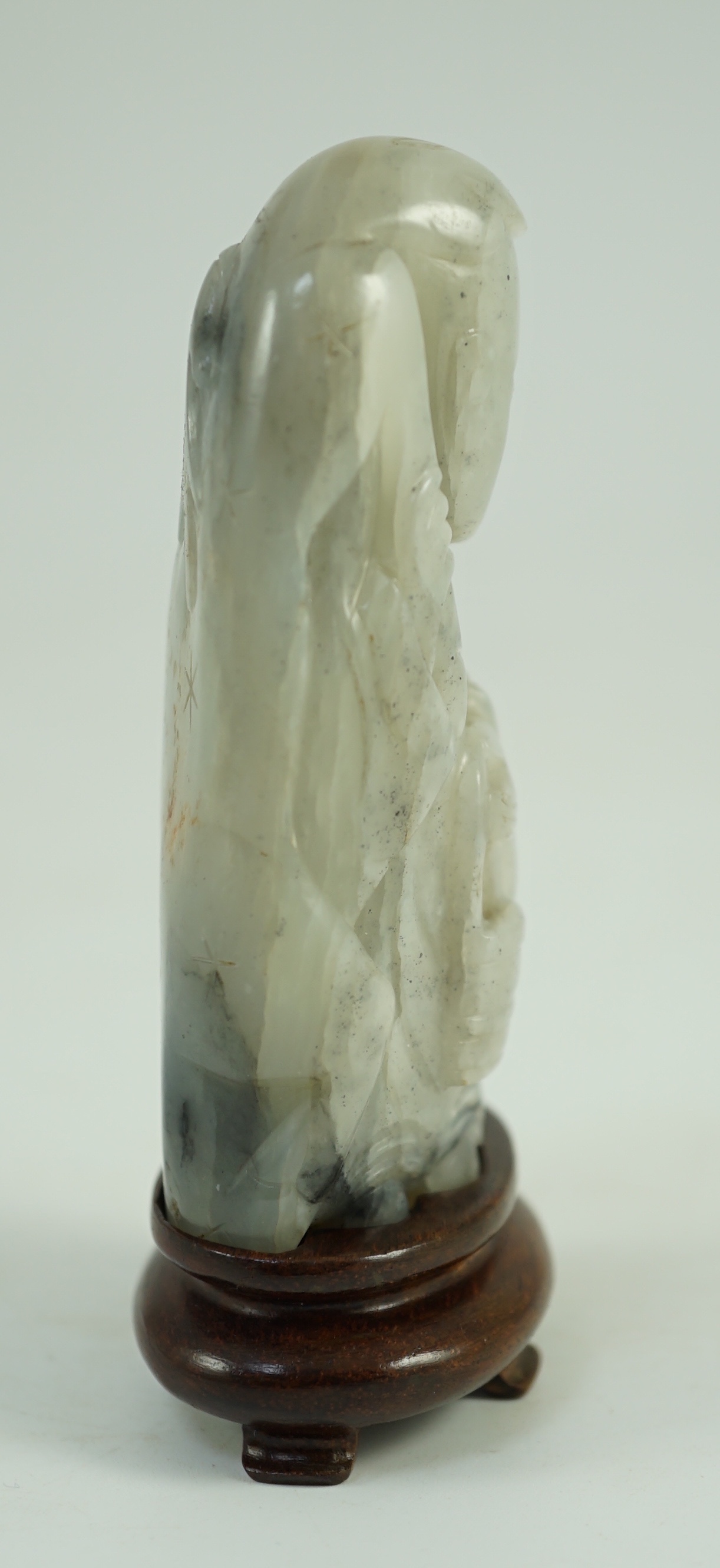 A Chinese white, grey and russet jade figure of Zhou Yanzi, Ming dynasty, 8.5cm high, Filled hole to figure, wood stand